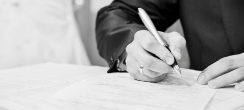 hand of a businessman signing a very important document