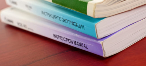Instructions manuals Instructionas manuals in english and russian on brown table